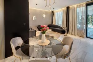 a dining room with a glass table and chairs at Hotel Posh in Split