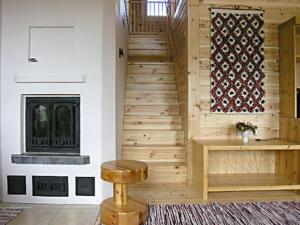 a staircase in a house with a fireplace at Holiday Home Iso marina by Interhome in Karvonen
