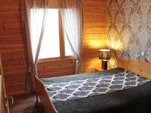 a bedroom with a bed and a window in a room at Holiday Home Akanlampi by Interhome in Karvonen