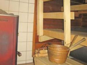 a kitchen with a bucket on top of a counter at Holiday Home Takaharju by Interhome in Karvonen