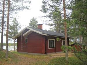 a small house in the middle of a forest at Holiday Home Takaharju by Interhome in Karvonen