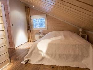 a bedroom with a large white bed in a attic at Holiday Home Oppas lapland levi by Interhome in Levi +5 photos