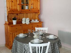 a table with a black and white polka dot table cloth at Chalet Le Clos des Sapins by Interhome in Monlet