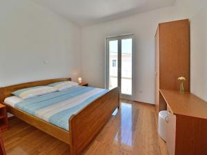 a bedroom with a bed and a large window at Apartment Golub-4 by Interhome in Cesarica