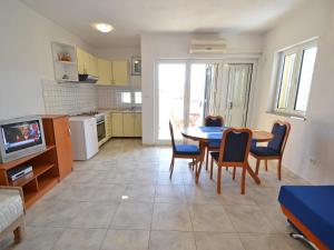 a kitchen and dining room with a table and chairs at Apartment Golub-2 by Interhome in Cesarica
