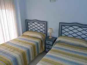two beds sitting next to each other in a bedroom at Apartment Medina Molins by Interhome in Denia