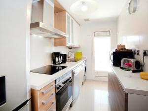 a kitchen with white counters and a stove top oven at Apartment Luz de Calpe I-3 by Interhome in Calpe +19 photos