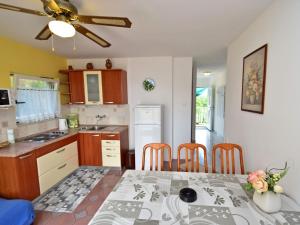 a kitchen and dining room with a table and chairs at Apartment Dada-2 by Interhome in Omišalj
