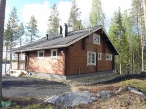 a small wooden house in the middle of a forest at Holiday Home Syvälahti by Interhome in Sonkajärvi