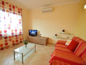 a living room with a couch and a tv at Holiday Home Jelka by Interhome in Njivice