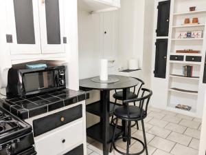 a small kitchen with a table and a microwave at Casa Bonita Apartments in Long Beach