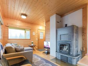 a living room with a fireplace and a couch at Holiday Home Mirus by Interhome in Böle