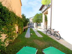 a backyard with two ping pong tables in the grass at Apartment Milano by Interhome in Forte dei Marmi