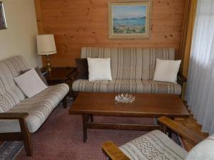 a living room with two couches and a coffee table at Apartment Oberland Nr- 29 by Interhome in Gstaad