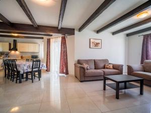 a living room with a couch and a table at Holiday Home Dorijano by Interhome in Ripenda Kras +31 photos
