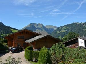 a couple of buildings with mountains in the background at Apartment Alegria - Parterre by Interhome in Gstaad