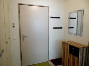 a large white door in a room with a mirror at Apartment Blumenweg 2 by Interhome in Engelberg