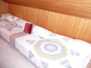 a room with two beds with a quilt on them at Apartment Berg by Interhome in Engelberg