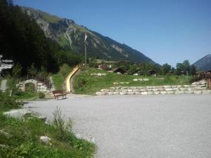a bench sitting on the side of a road at Apartment Kronenplatz 7 # 3 by Interhome in Lenk