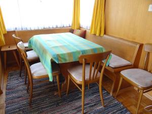 a table and chairs in a room with a table and a window at Apartment Steinacher by Interhome in Engelberg