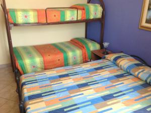 a bedroom with two bunk beds in a room at Villa Marco Polo in Fanusa