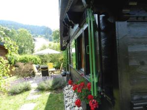 a house with flowers on the side of it at Apartment Abnaki- Chalet by Interhome in Gstaad