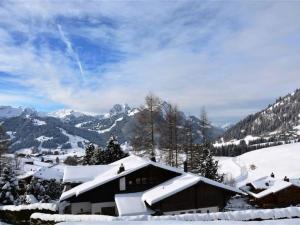 a ski lodge in the snow on a mountain at Apartment Scapa by Interhome in Gstaad