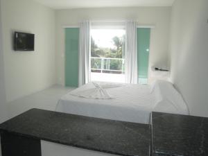 Una cama o camas en una habitación de Pousada Lessence By Solarium