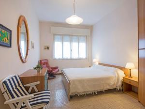 ヴィアレッジョにあるApartment Appartamento Luporini by Interhomeのベッドルーム1室(ベッド1台、デスク、椅子付)