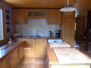 a kitchen with wooden cabinets and a sink at Holiday Home Lac et Forêt by Interhome in Le Moutchic