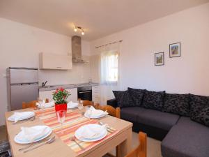 a living room with a table and a couch at Apartment Jasminka-1 by Interhome in Drage