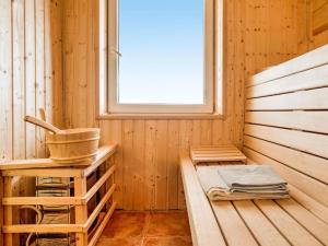 a wooden sauna with a tub and a window at Holiday Home Stana by Interhome in Klenovica