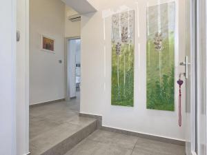 a hallway with two paintings on the wall at Holiday Home Lino by Interhome in Štinjan +29 photos