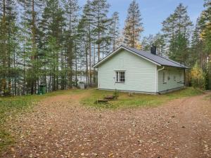 a white house in the middle of a dirt road at Holiday Home Päivärinne by Interhome in Vuoriniemi
