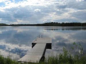 a dock in the middle of a large lake at Holiday Home Varvali by Interhome in Lahdenkylä