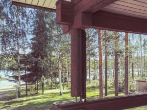 a view from the porch of a house looking out at the trees at Holiday Home Villa kontio by Interhome in Savonranta