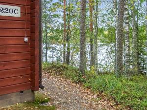 a house with a sign on the side of a dirt road at Holiday Home 2233 by Interhome in Savonranta
