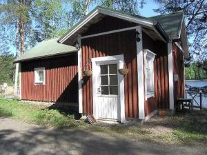 a small red and white building with a door at Holiday Home Hannala by Interhome in Muurame