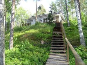 a house with stairs leading up to a house at Holiday Home Harjunniemi by Interhome in Vilppula