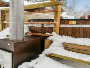a pile of snow next to a wooden fence at Holiday Home Rantamaja by Interhome in Kittilä
