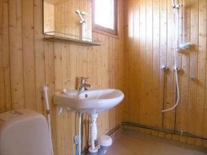 a bathroom with a sink and a shower and a toilet at Holiday Home Karpalo by Interhome in Jokijärvi