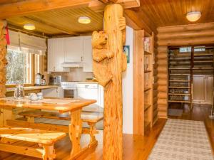 a kitchen with a wooden table in a cabin at Holiday Home Karhulinna by Interhome in Miehoila