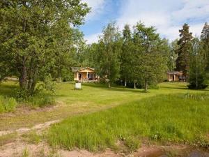 a house in the middle of a field with trees at Holiday Home Keltavuokko by Interhome in Sipsiö