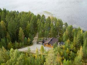 an aerial view of a house on a hill near the water at Holiday Home Riutankolo by Interhome in Lipinlahti