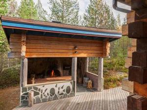 a outdoor fireplace with a roof on a deck at Holiday Home Riutankolo by Interhome in Lipinlahti