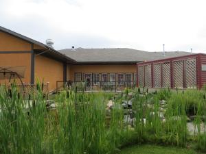a building with a garden in front of it at Village Creek Country Inn in Westerose