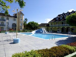 a pool with a slide in the middle of a building at Beach One Bedroom Suite A17 in Ocho Rios