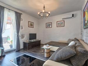 a living room with a couch and a tv at Holiday Home Stefanina by Interhome in Labin