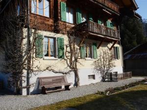 a building with a bench in front of it at Apartment Margrit by Interhome in Gstaad