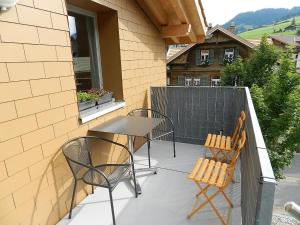 a patio with a table and chairs on a balcony at Apartment Simme-Tröimli by Interhome in Zweisimmen